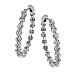 These elegant white gold hoops sparkle with .99 ctw of white diamonds