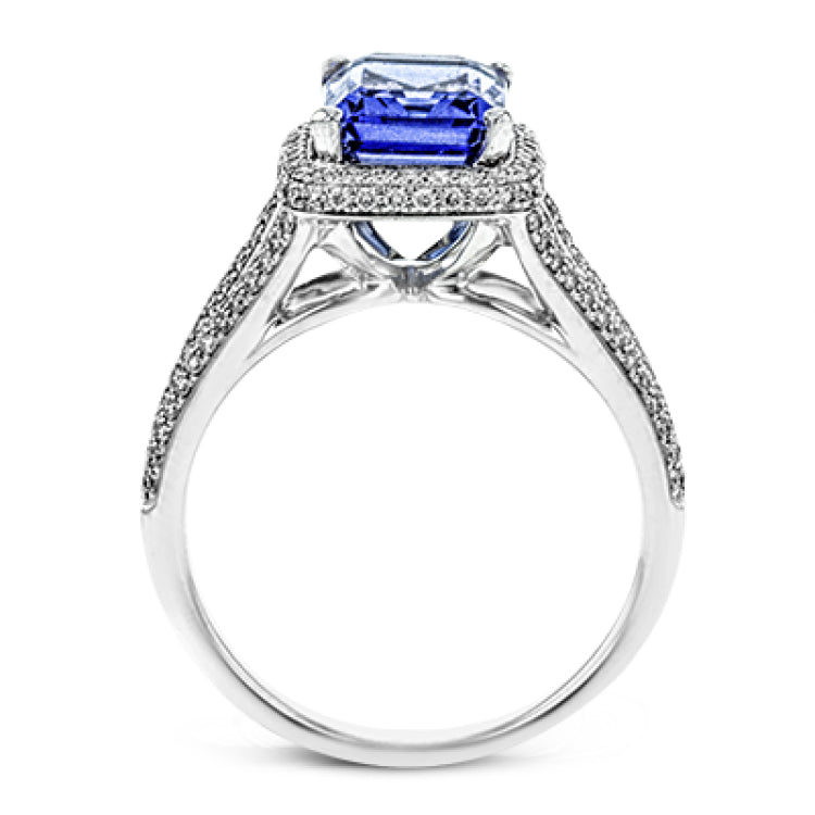 This splendid white gold ring features a delicate split shank and halo, set with .46 ctw of round white diamonds, framing a lovely 2.71 ctw emerald cut tanzanite.