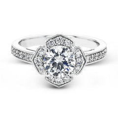 A floral inspired diamond engagement rng 0.35 ctw. has a vintage touch of milgrain beading, and is made to hold a 1.0 ct center