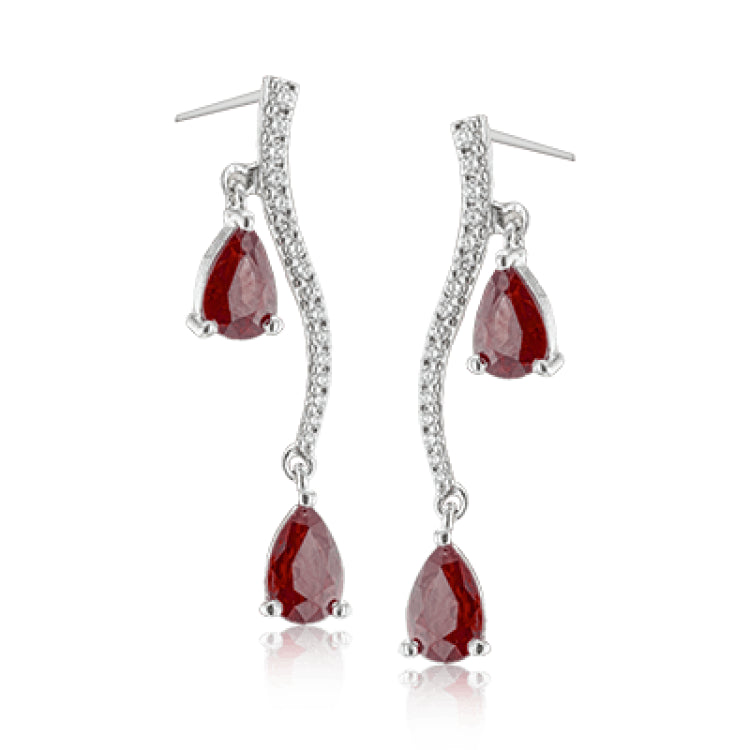 2.07 ctw of elegant ruby teardrops are complemented by .16 ctw of white diamonds in these opulent, glamorous white gold earrings