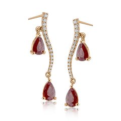 2.07 ctw of elegant ruby teardrops are complemented by .16 ctw of white diamonds in these opulent, glamorous white gold earrings