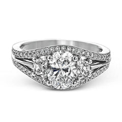 This remarkable white gold ring shows off an oval shaped centerpiece flanked by .47 ctw of trapezoid shaped white diamonds alongside .27 ctw of round white diamonds.
