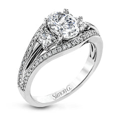 This remarkable white gold ring shows off an oval shaped centerpiece flanked by .47 ctw of trapezoid shaped white diamonds alongside .27 ctw of round white diamonds.