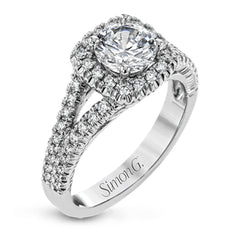 This elegant, contemporary design in white gold sparkles with .45 ctw of round white diamonds in its halo and split shank.