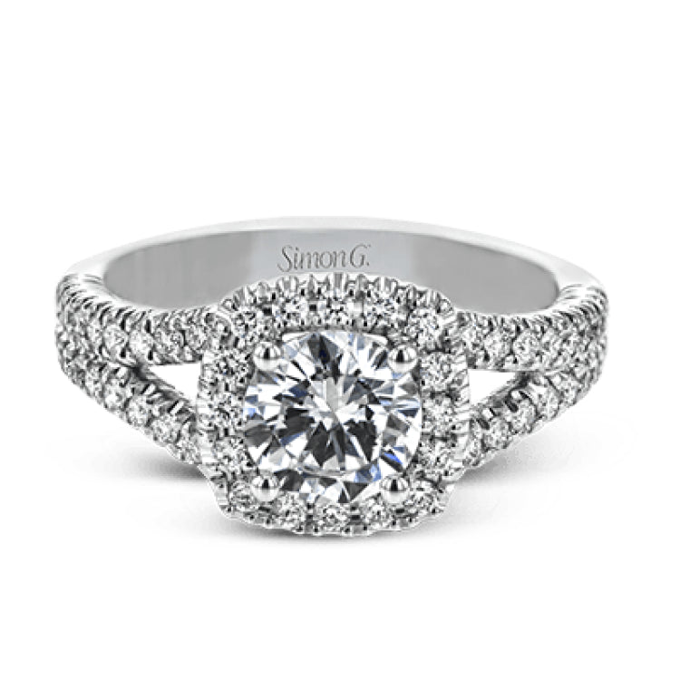 This elegant, contemporary design in white gold sparkles with .45 ctw of round white diamonds in its halo and split shank.