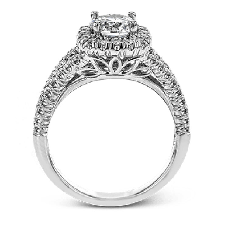 This elegant, contemporary design in white gold sparkles with .45 ctw of round white diamonds in its halo and split shank.
