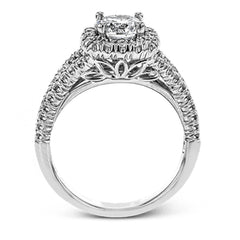 This elegant, contemporary design in white gold sparkles with .45 ctw of round white diamonds in its halo and split shank.