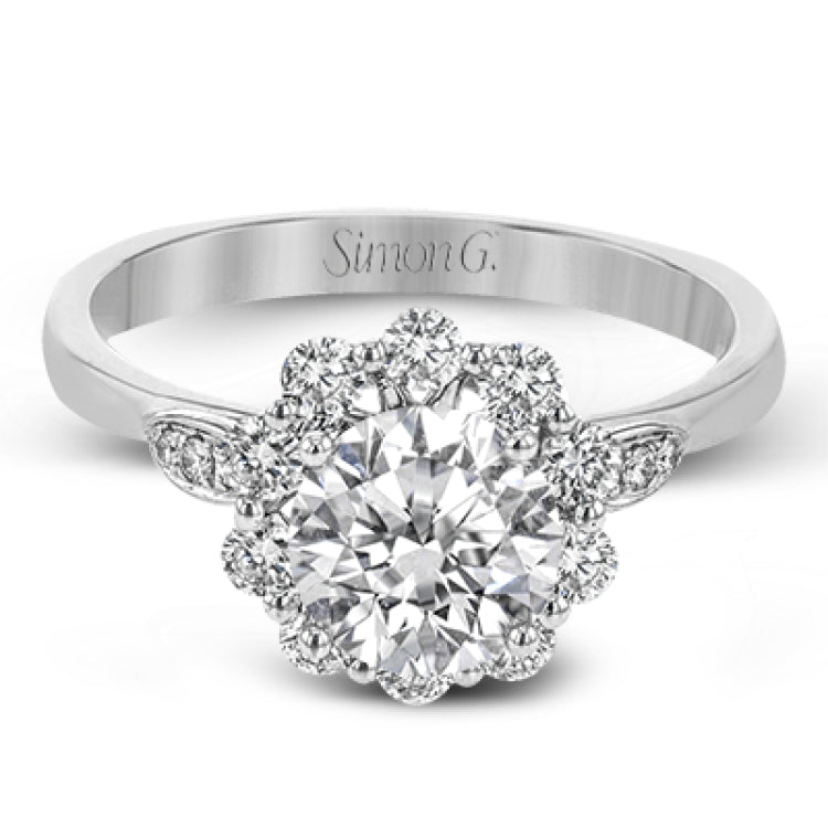 This stunning, contemporary design features .36 ctw of round white diamonds set in its exaggerated halo and delicate side details to evoke a charming floral motif.