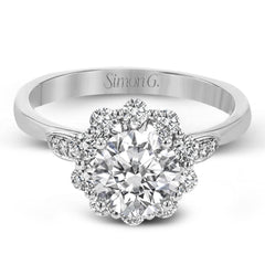 This stunning, contemporary design features .36 ctw of round white diamonds set in its exaggerated halo and delicate side details to evoke a charming floral motif.