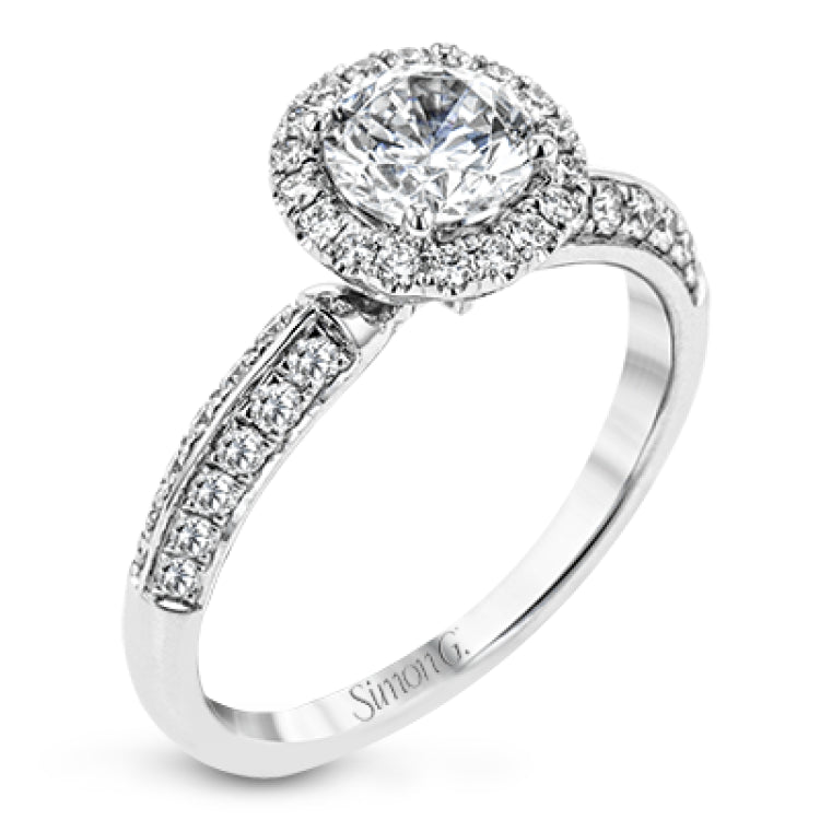 This delicate, vintage-inspired engagement ring sparkles with .42 ctw of round white diamonds in its halo and side details, all set in beautiful white gold.