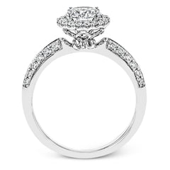 This delicate, vintage-inspired engagement ring sparkles with .42 ctw of round white diamonds in its halo and side details, all set in beautiful white gold.