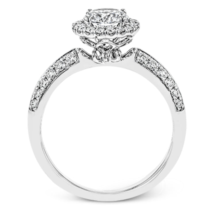 This delicate, vintage-inspired engagement ring sparkles with .42 ctw of round white diamonds in its halo and side details, all set in beautiful white gold.
