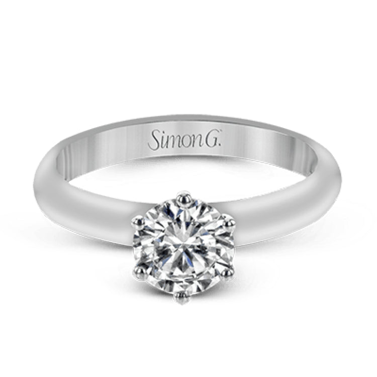 This beautifully simple design in white gold is the perfect setting to let a single round stone shine.