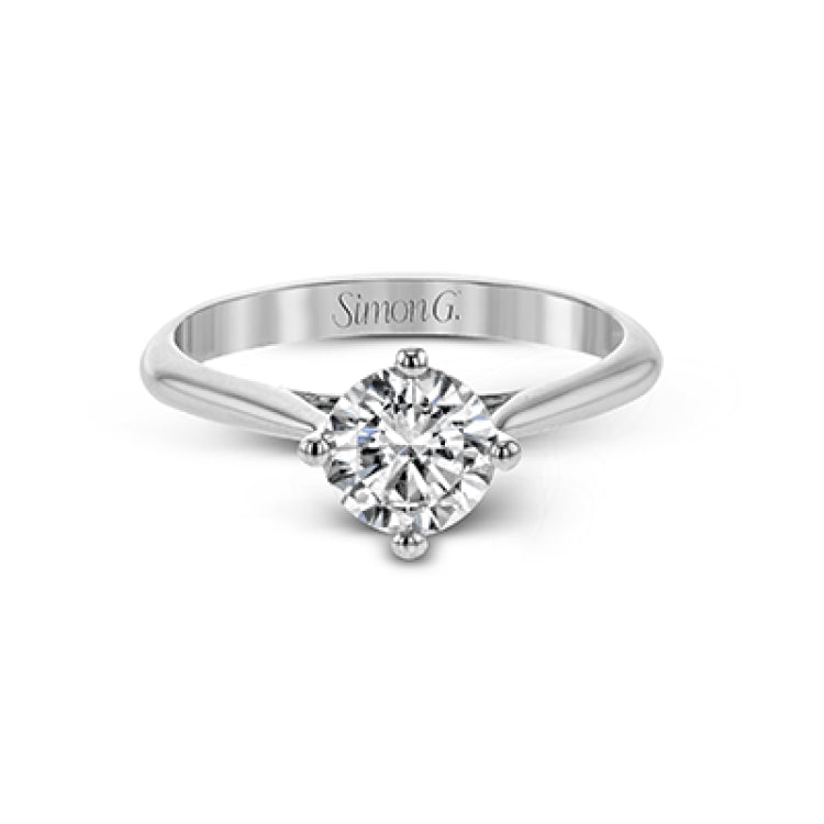The clean lines of this white gold ring perfectly frame a single round stone as a centerpiece.
