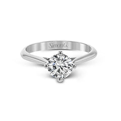 The clean lines of this white gold ring perfectly frame a single round stone as a centerpiece.