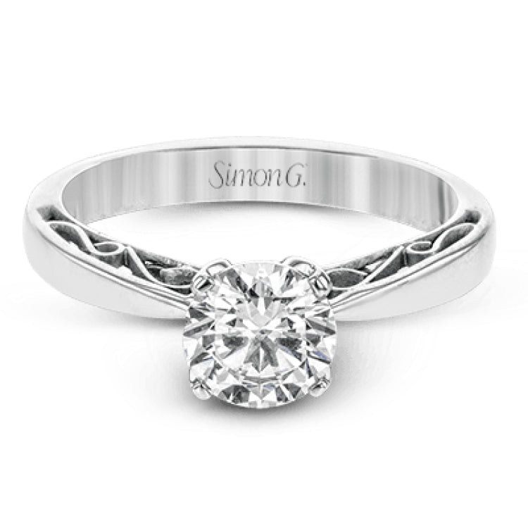 This sleek, elegant white gold ring features delicate filigree detailing to accentuate its single, central stone.
