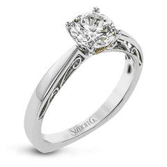 This sleek, elegant white gold ring features delicate filigree detailing to accentuate its single, central stone.