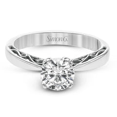 This sleek, elegant white gold ring features delicate filigree detailing to accentuate its single, central stone.