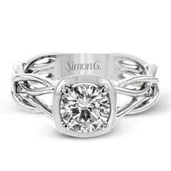 The flowing, organic lines of this contemporary, nature-inspired white gold ring provide a beautifully understated setting for a single, central stone.