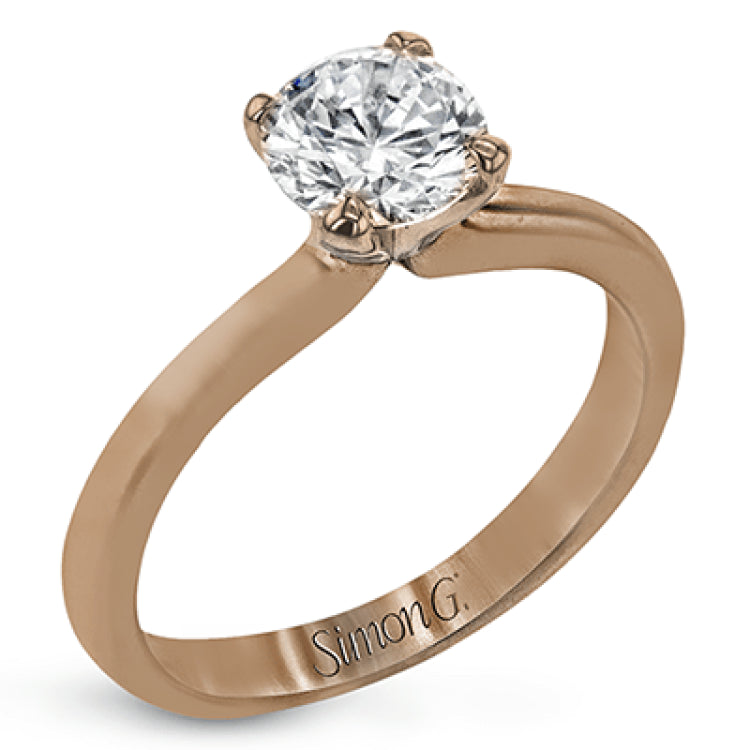 This sleek, unadorned white gold ring provides an elegantly modern setting for a single, central stone.