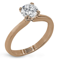 This sleek, unadorned white gold ring provides an elegantly modern setting for a single, central stone.