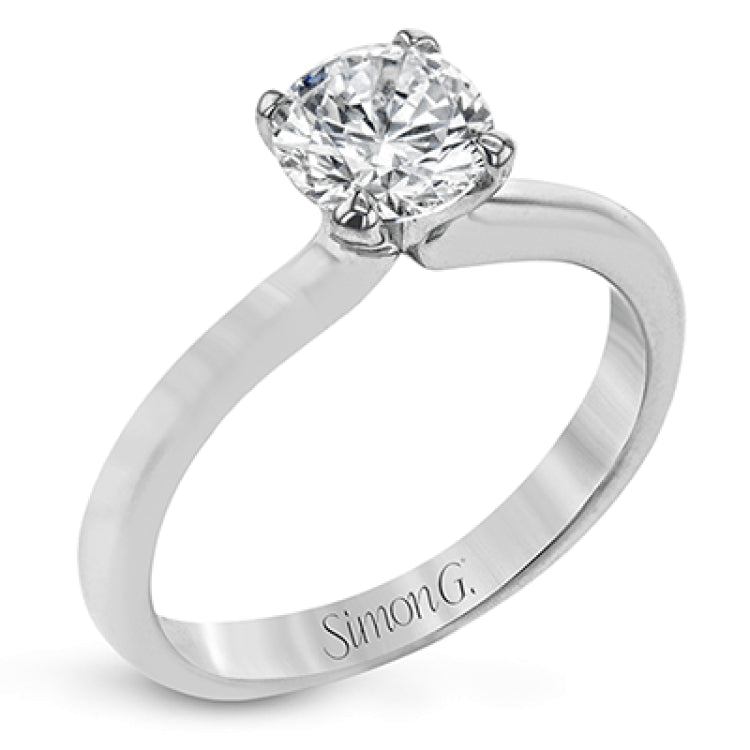 This sleek, unadorned white gold ring provides an elegantly modern setting for a single, central stone.