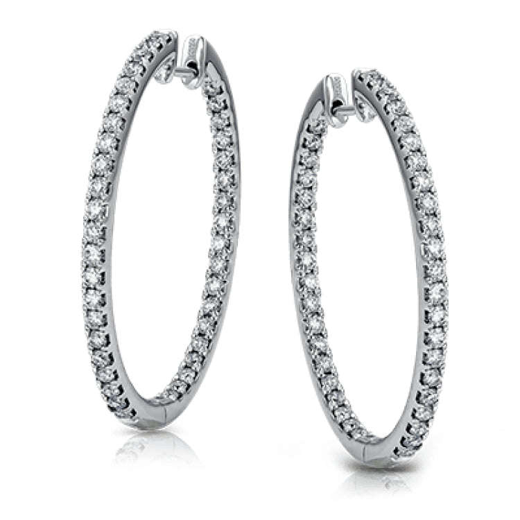 Dramatic yet refined, these white gold earrings contain 1.52 ctw of white diamonds