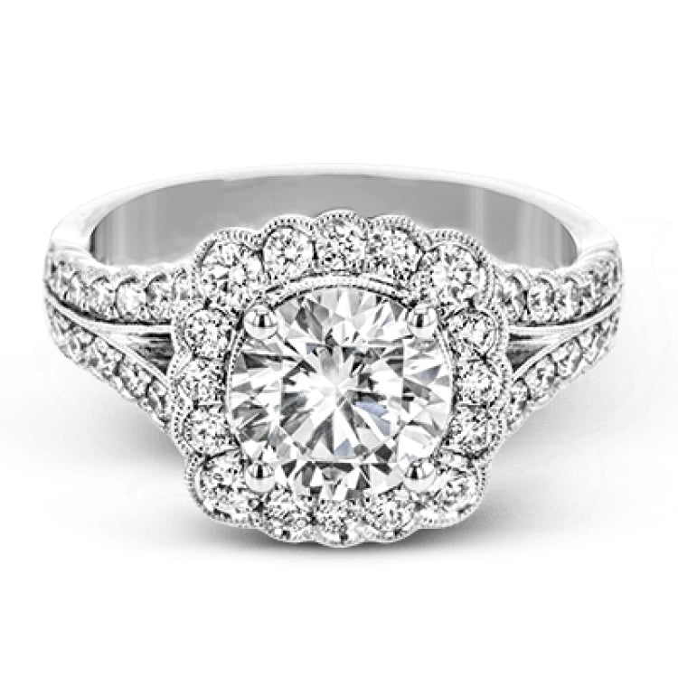 This engagement ring has a unique design with a halo of bezel set diamonds. The setting contains .81 ctw of white diamonds.