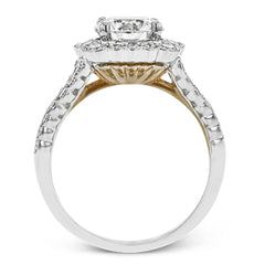 This engagement ring has a unique design with a halo of bezel set diamonds. The setting contains .81 ctw of white diamonds.
