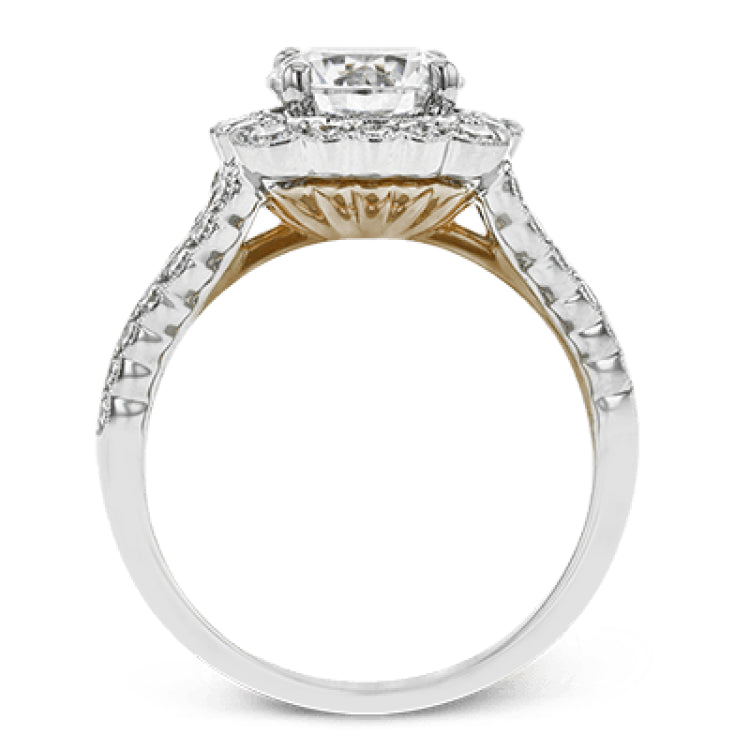 This engagement ring has a unique design with a halo of bezel set diamonds. The setting contains .81 ctw of white diamonds.