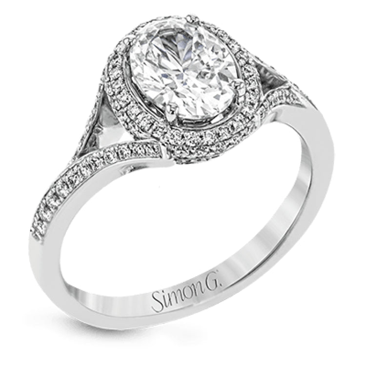 Elegant and sophisticated, this white gold ring's delicate halo and split shank glitter with .28 ctw of round white diamonds to highlight an oval shaped center stone.