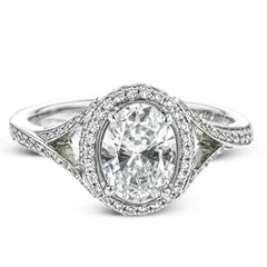 Elegant and sophisticated, this white gold ring's delicate halo and split shank glitter with .28 ctw of round white diamonds to highlight an oval shaped center stone.