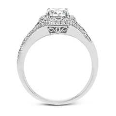 Elegant and sophisticated, this white gold ring's delicate halo and split shank glitter with .28 ctw of round white diamonds to highlight an oval shaped center stone.