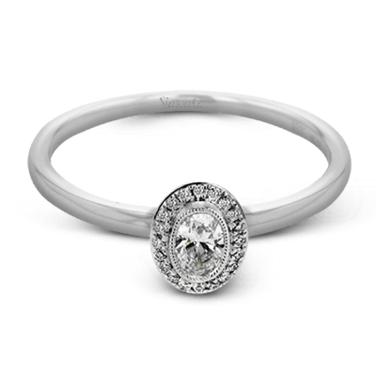 This exquisite, minimalist white gold ring features a halo containing .05 ctw of round white diamonds encircling a .17 ctw oval shaped white diamond
