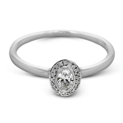 This exquisite, minimalist white gold ring features a halo containing .05 ctw of round white diamonds encircling a .17 ctw oval shaped white diamond