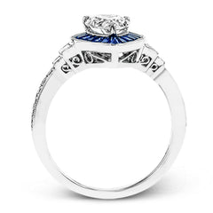 This beautiful pear-shaped setting displays .82 ctw of baguette sapphires in a halo around the center stone. The rest of the ring sparkles with .11 ctw of round diamonds and .17 ctw of baguette diamonds.