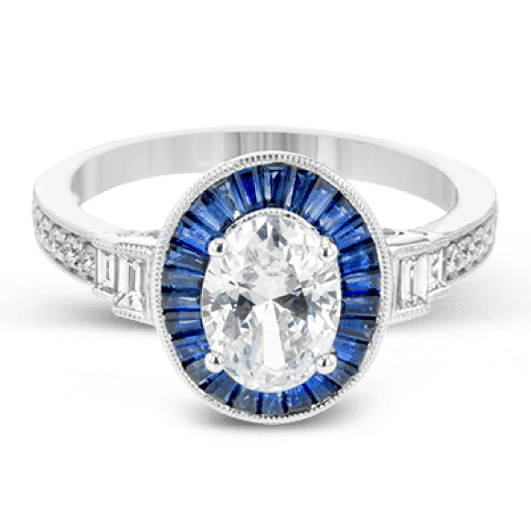 This remarkable ring features milgrain edging and .75 ctw of baguette shaped sapphires in its halo, flanked by .11 ctw of round white diamonds and .16 ctw of baguette shaped white diamonds.
