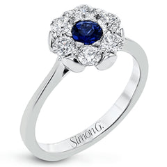 Radiate elegance with this white gold ring's exquisite floral-inspired design, featuring a cluster of .66 ctw of round white diamonds