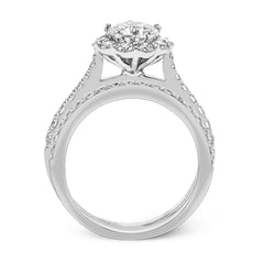 This white gold wedding set frames its centerpiece with .90 ctw of round white diamonds in a whimsical floral-inspired design.