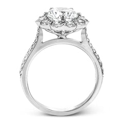 This white gold wedding set frames its centerpiece with .90 ctw of round white diamonds in a whimsical floral-inspired design.
