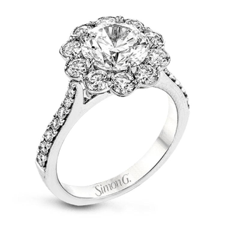 This white gold wedding set frames its centerpiece with .90 ctw of round white diamonds in a whimsical floral-inspired design.