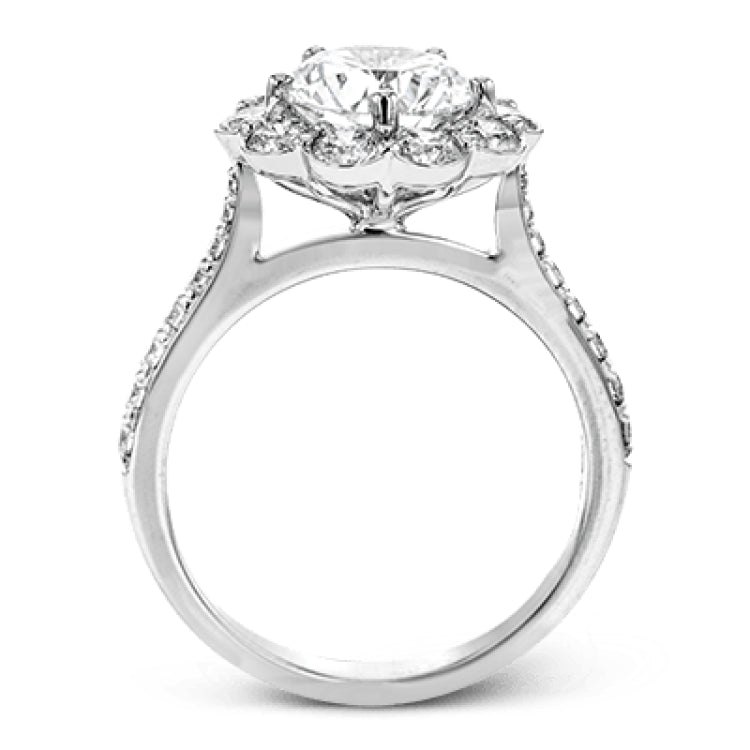 This white gold wedding set frames its centerpiece with .90 ctw of round white diamonds in a whimsical floral-inspired design.