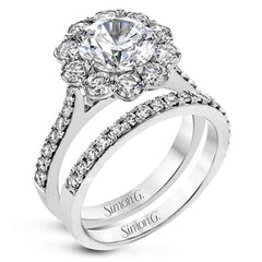 This white gold wedding set frames its centerpiece with .90 ctw of round white diamonds in a whimsical floral-inspired design.