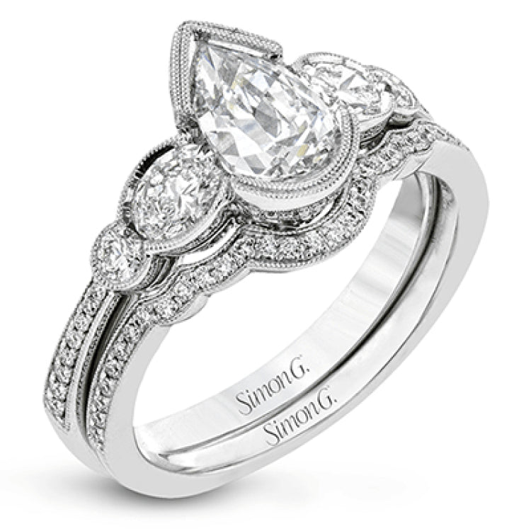 This lovely contemporary design features white gold and .14 ctw of round white diamonds and .42 ctw of oval shaped white diamonds as well as delicate milgrain edging around its centerpiece.