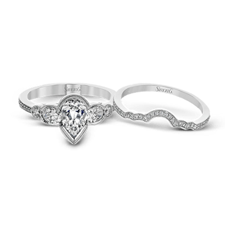 This lovely contemporary design features white gold and .14 ctw of round white diamonds and .42 ctw of oval shaped white diamonds as well as delicate milgrain edging around its centerpiece.