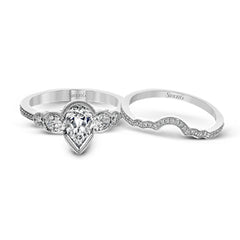 This lovely contemporary design features white gold and .14 ctw of round white diamonds and .42 ctw of oval shaped white diamonds as well as delicate milgrain edging around its centerpiece.