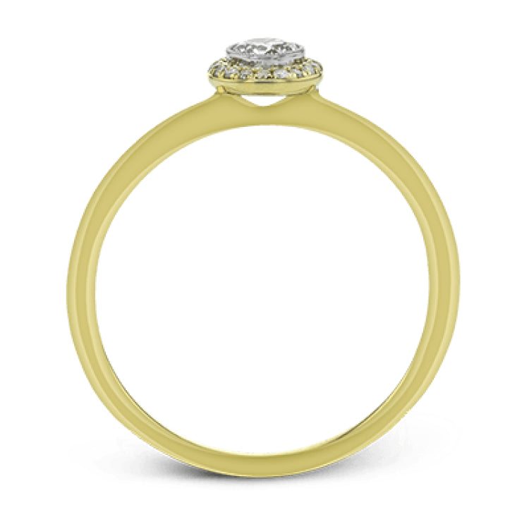 This exquisite, minimalist yellow gold ring features a halo containing .04 ctw of round white diamonds encircling a .16 ctw round white diamond centerpiece