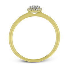 This exquisite, minimalist yellow gold ring features a halo containing .04 ctw of round white diamonds encircling a .16 ctw round white diamond centerpiece