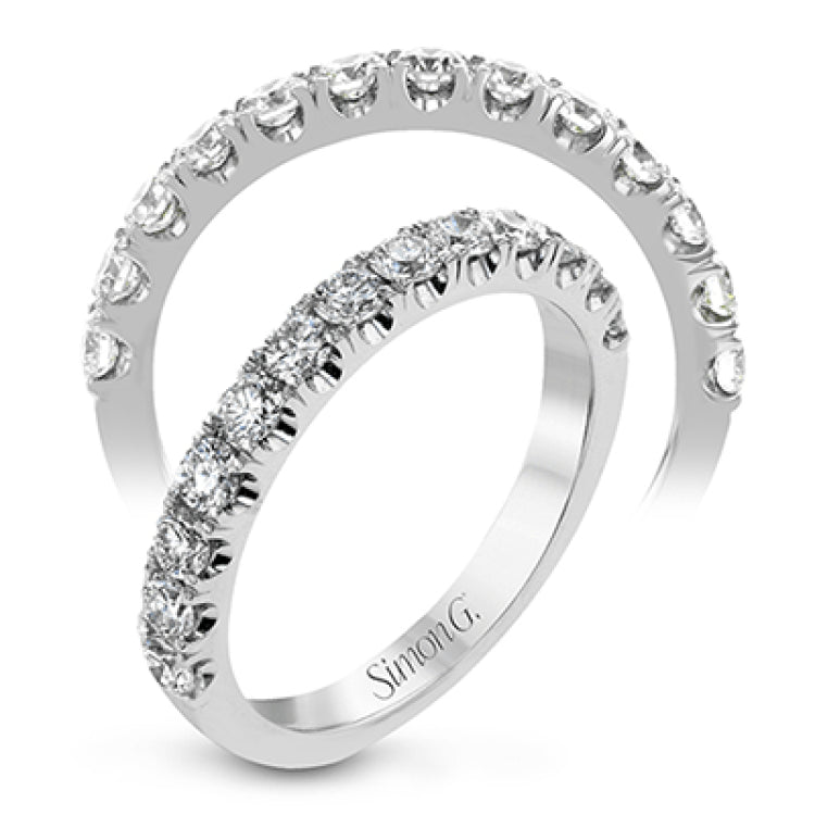 This wedding band has a beautiful timeless design which will be in style for years. The ring contains .77 ctw of white diamonds.