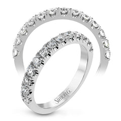 This wedding band has a beautiful timeless design which will be in style for years. The ring contains .77 ctw of white diamonds.